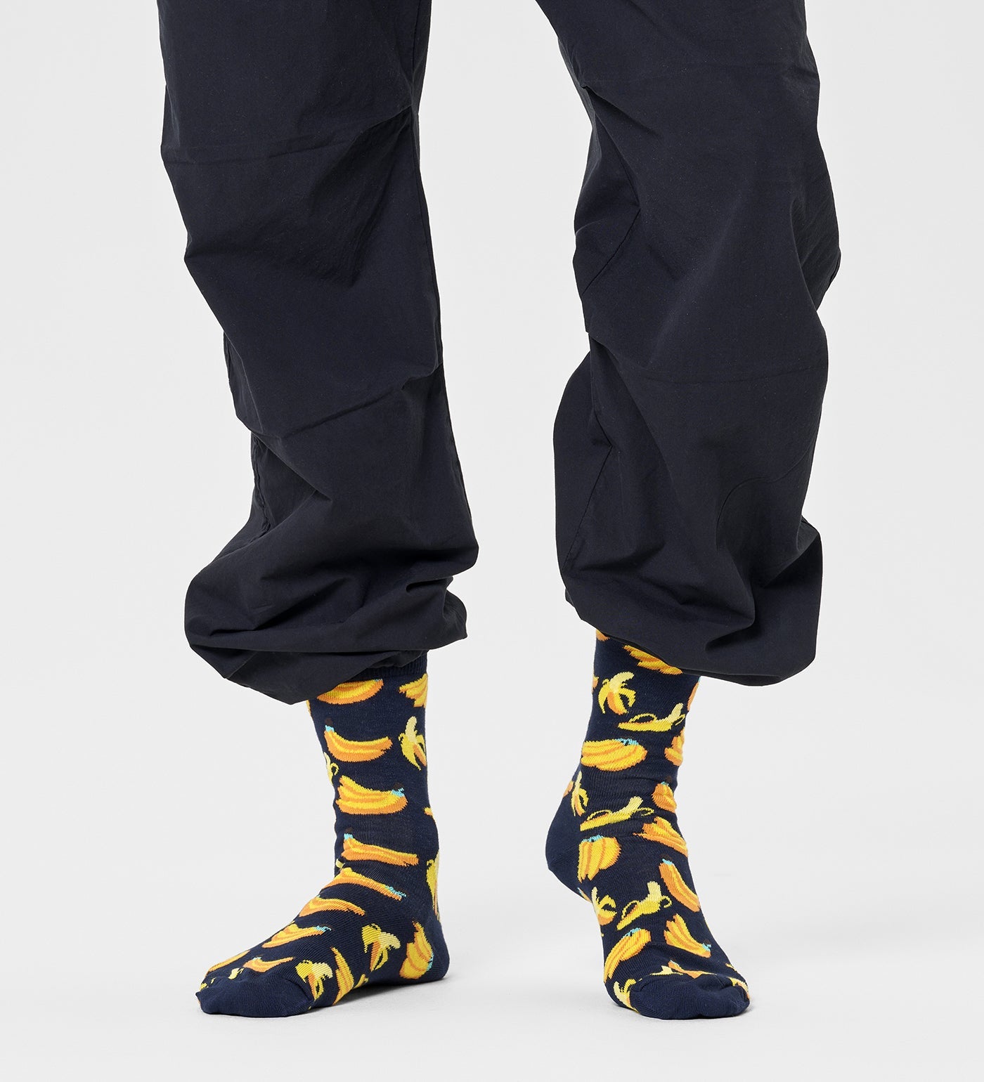 Bright yellow Happy Socks unisex banana crew socks featuring playful banana illustrations, suitable for women and men.
