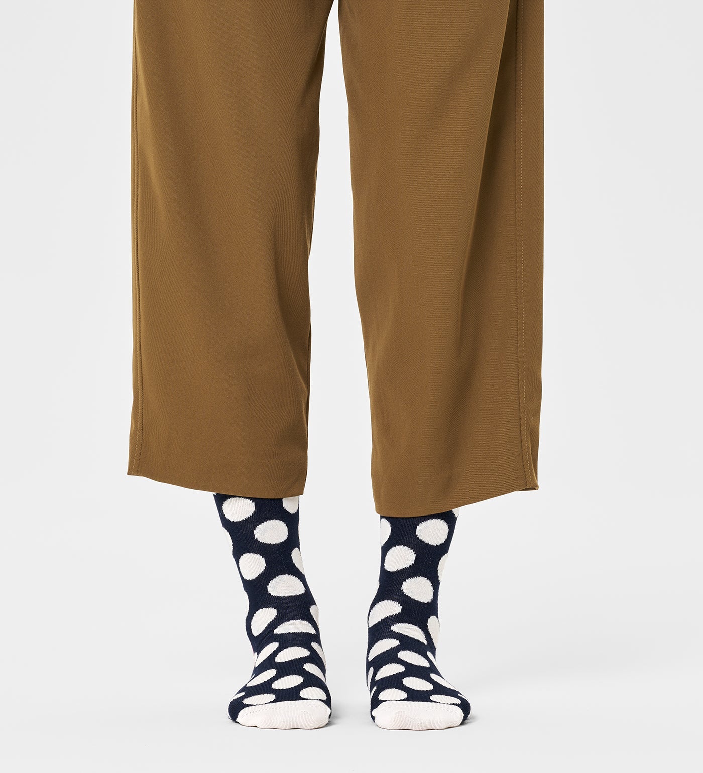 Colorful unisex crew socks featuring large dot patterns, suitable for women and men, by Happy Socks.