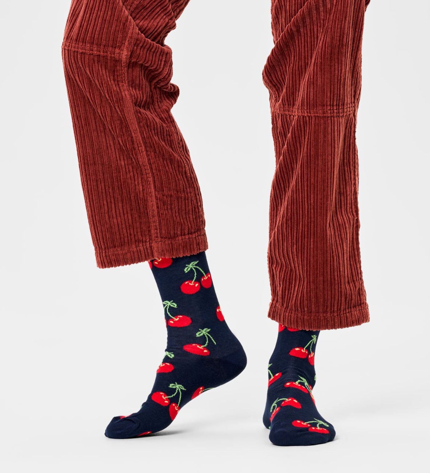 Bright red cherry design on unisex crew-length socks suitable for women and men, stylish and comfortable for everyday wear.