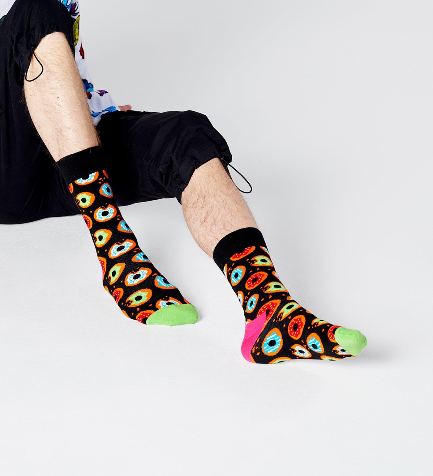 Bright, colorful donut pattern on unisex crew socks for women and men, fun and comfy accessory for any outfit.