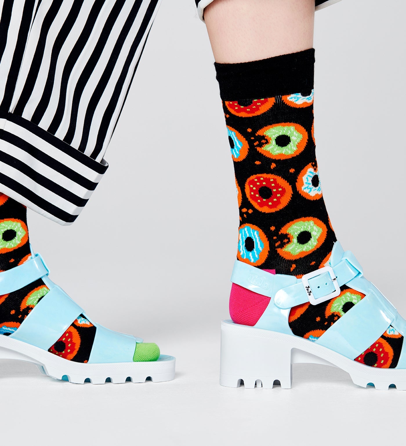 Bright, colorful donut pattern on unisex crew socks for women and men, fun and comfy accessory for any outfit.