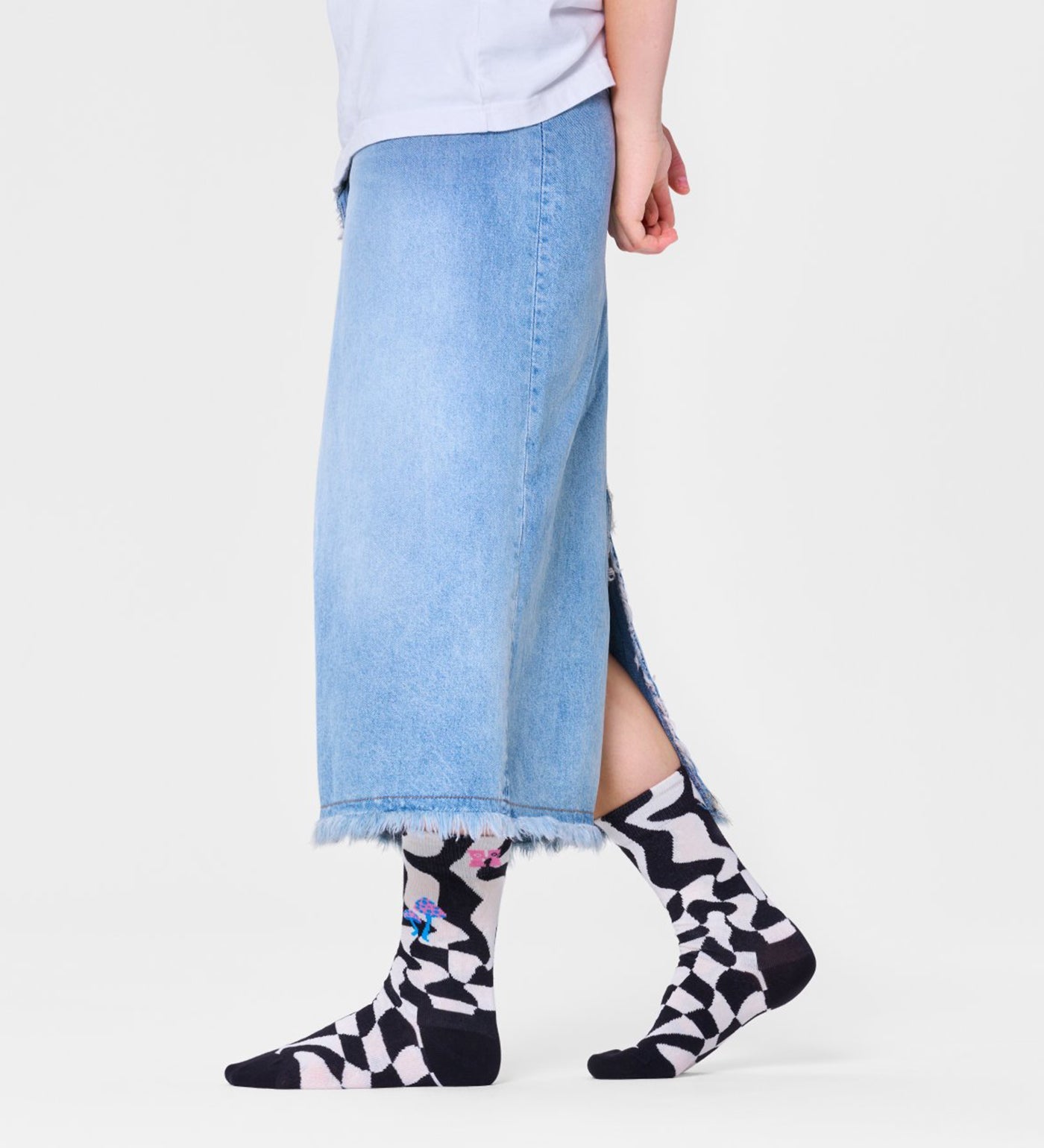 Bright, playful unisex crew socks featuring a distorted checkered pattern, suitable for women and men.