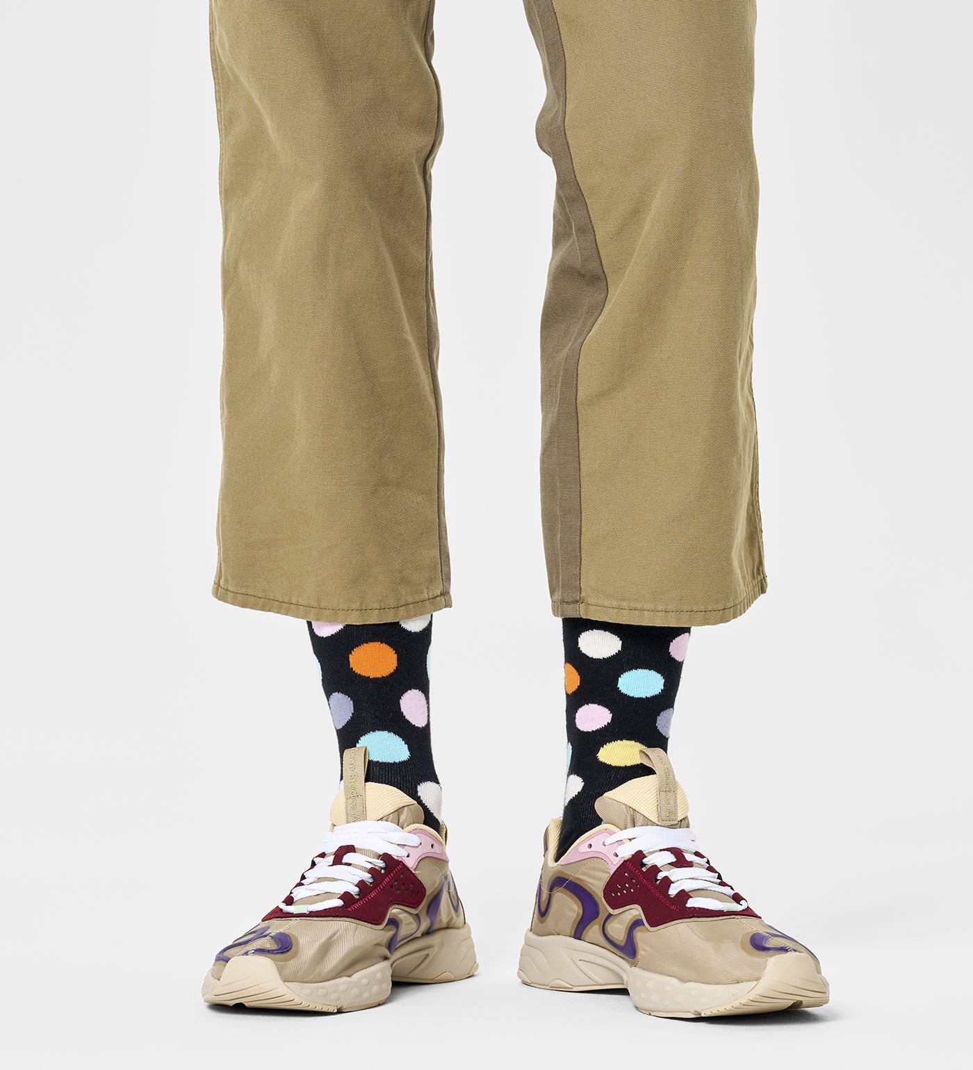 Colorful unisex crew socks featuring large dot patterns, suitable for women and men, by Happy Socks.