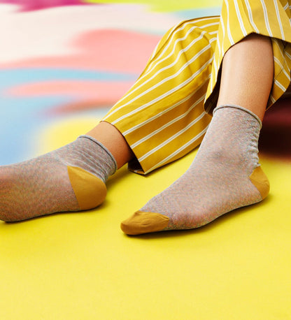 Brightly patterned Happy Socks Emma calf-length socks for women, offering vibrant style and comfortable fit for everyday wear.
